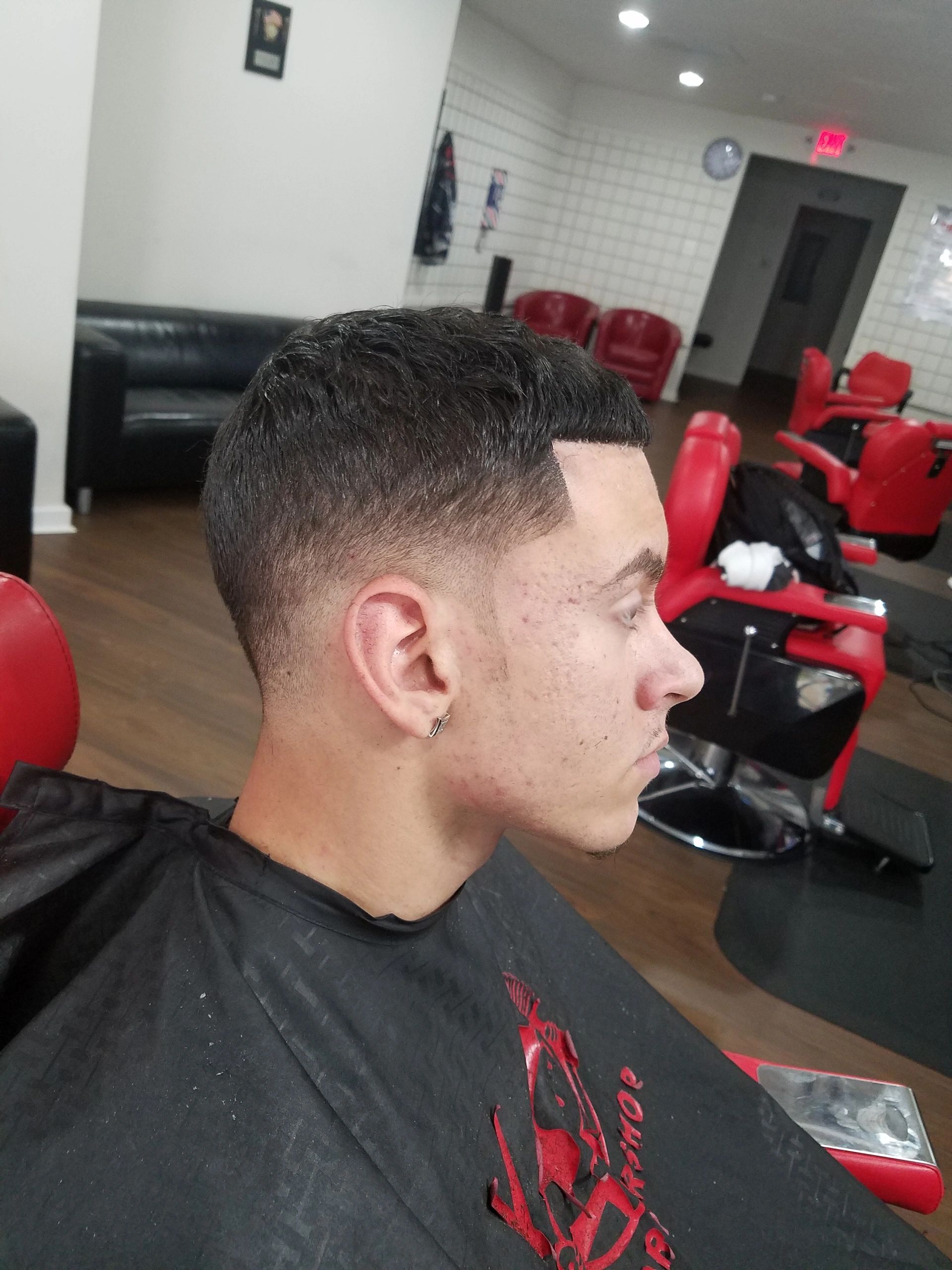 Barbershop interior with red and black chairs